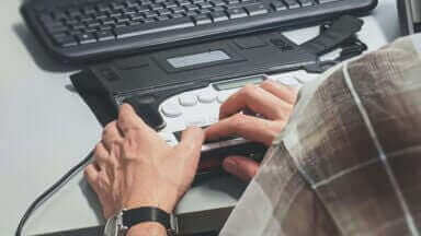 En person anvender et braille tastatur, stock foto, unsplash